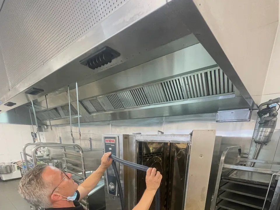 Catering equipment repairs Perth: Electeq technician working on a combi oven in a commercial kitchen