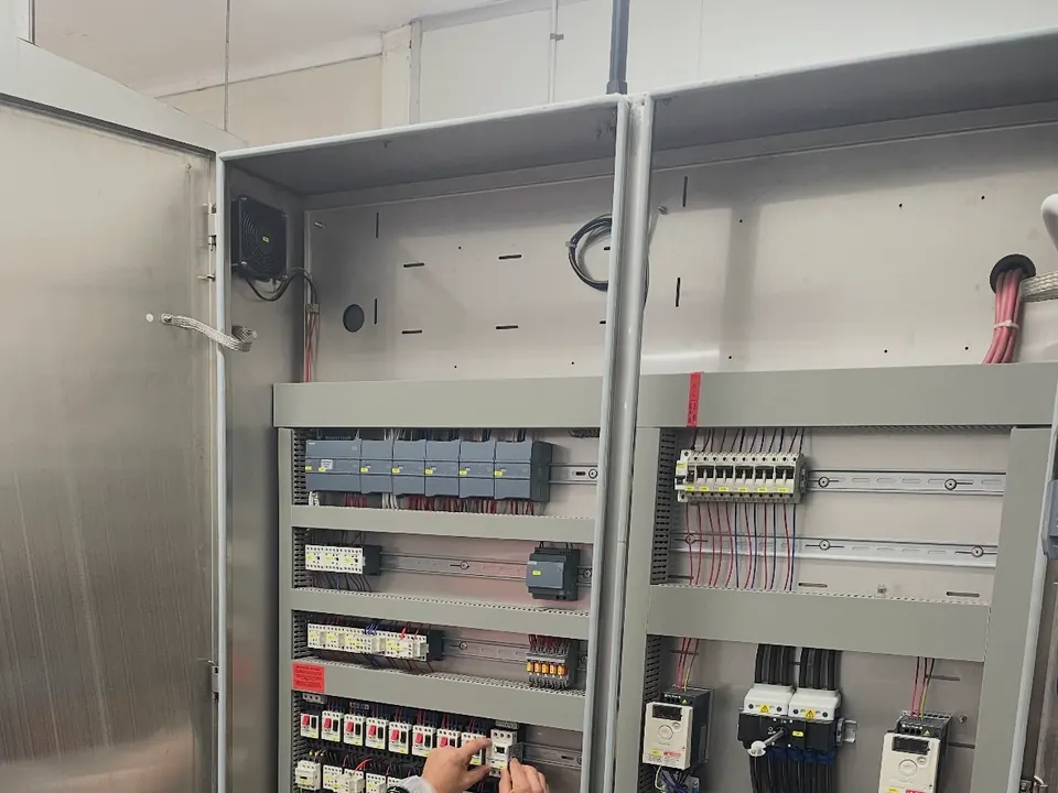 Commercial food equipment repairs Perth: Electeq technician testing a control cabinet in a food production facility