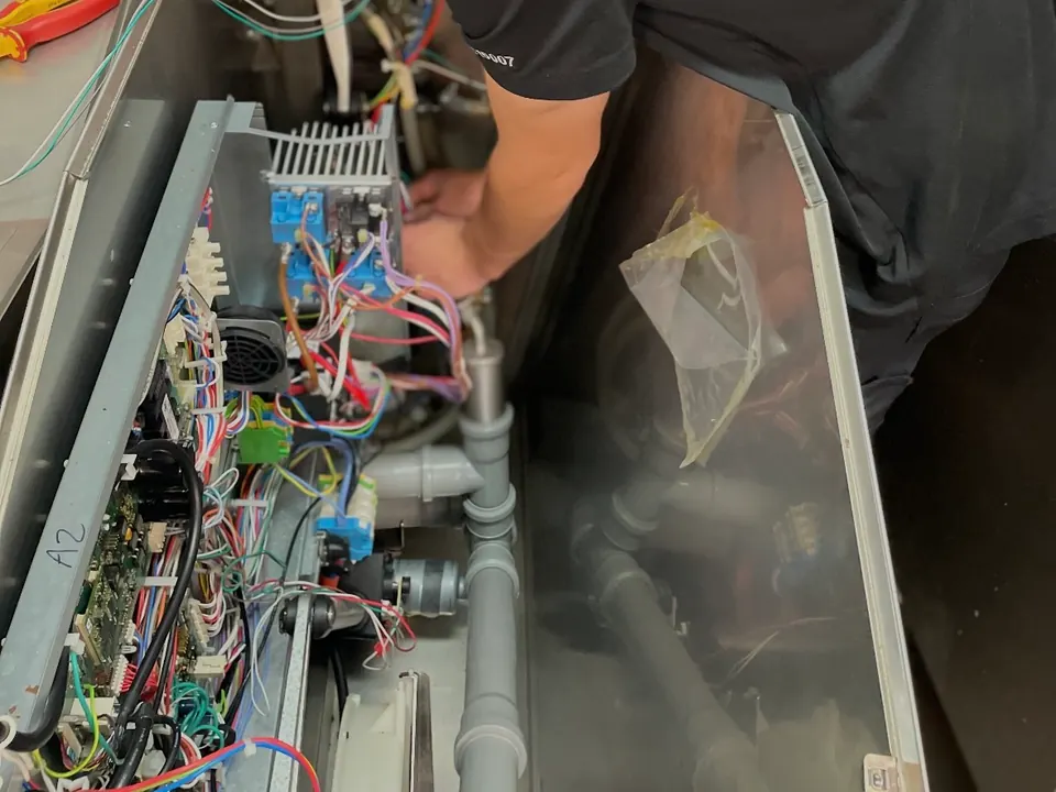 Commercial kitchen equipment repair Perth: Electeq technician tracing a fault on equipment control boards