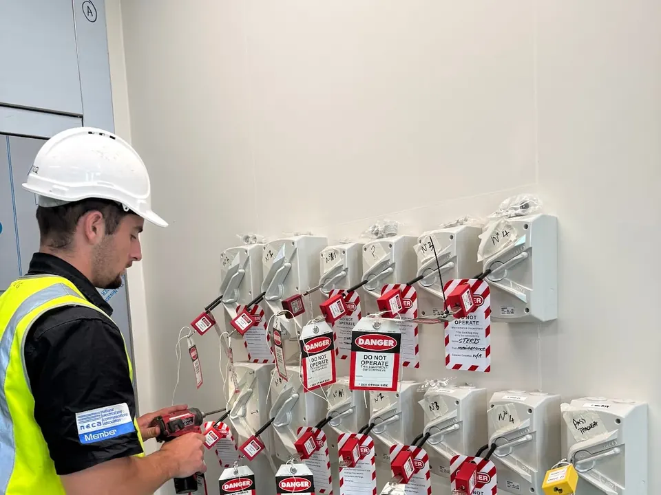 Commercial kitchen maintenance: Electeq technician with isolators locked out and tagged before work begins